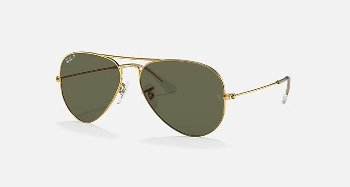 The Ray-Ban 3025 Aviator sunglasses feature gold metal frames and dark green lenses in a classic pilot shape, displayed on a plain light background.
