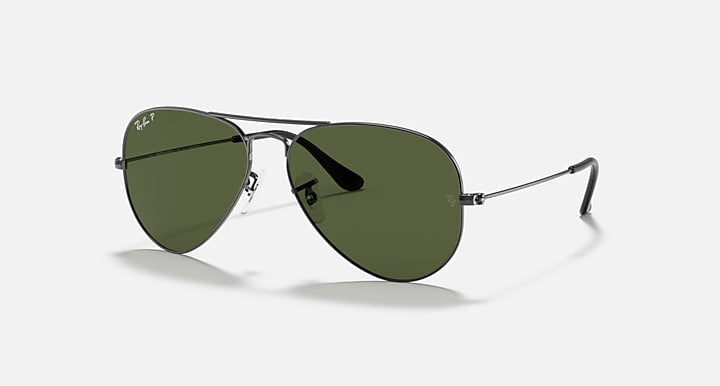 A pair of Ray-Ban 3025 Aviator black metal sunglasses with dark green lenses, showcased on a white background.