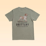 Olive green Bird Dog Series Shirt | Brittany featuring a back graphic of a Brittany spaniel with the text “TRUE COMPANIONSHIP,” “BRITTANY,” and “BALLAD OF THE BIRD DOG.”