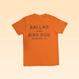 Orange Upland Shirt with a comfortable everyday fit, featuring “BALLAD of the BIRD DOG BRENHAM, TX” printed on the back.
