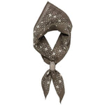 The Jenni Earle "Feel the Fear, Do It Anyway" Bandana is a brown luxury cotton accessory with a white geometric pattern, folded and tied for classic western style.