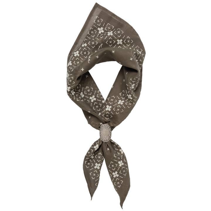 The Jenni Earle "Feel the Fear, Do It Anyway" Bandana is a brown luxury cotton accessory with a white geometric pattern, folded and tied for classic western style.