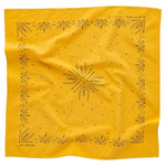 The "Just Breathe" bandana by Jenni Earle is yellow, hand-dyed, and features a black geometric and botanical pattern with a central symmetrical design and decorative border elements.