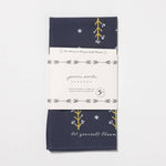 The Jenni Earle "Let Yourself Bloom" Bandana is hand-dyed in navy blue with a floral design and message, wrapped in branded paper and made from sustainable cotton for feel-good style.