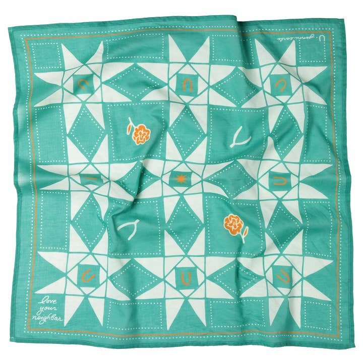 The Jenni Earle "Love Your Neighbor" bandana features a teal and white geometric star pattern with orange floral accents and the phrase "Love your neighbor" in one corner.