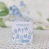 A box of Old Whaling Co. Bath Bombs in the Floral Coast scent rests on a white woven surface, with soft hydrangea notes and a subtle floral backdrop.