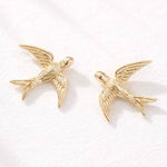 Introducing the Mesa Blue Swallow Stud Earrings—18K gold plated and delicately crafted in the shape of flying birds. These lightweight earrings from Mesa Blue are elegantly displayed on a white surface, adding a stylish touch to any look.