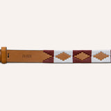 The Big Bend by Zilker Belts is a tan Argentine leather belt featuring a brass buckle, maroon and white woven geometric patterns, hand-stitched detailing, and "ZILKER" stamped on the belt.