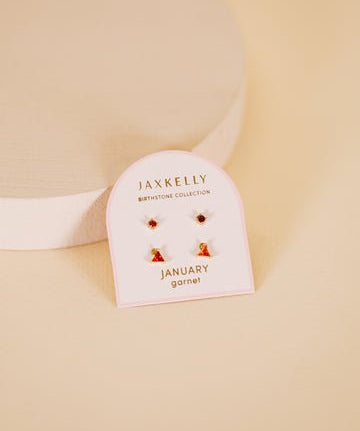 JaxKelly Birthstone Earrings for January feature garnet stones and hypoallergenic sterling silver posts, displayed on a “Birthstone Collection January garnet” card against a beige background.