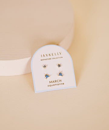 JaxKelly Birthstone Earrings for March, featuring aquamarine stones and hypoallergenic sterling silver posts, are shown on a branded card labeled "March aquamarine" against a neutral background.