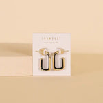 JaxKelly Black Enamel Large Rectangle Gold Hoop Earrings, designed to be hypoallergenic, are displayed on a white JaxKelly card against a beige background.