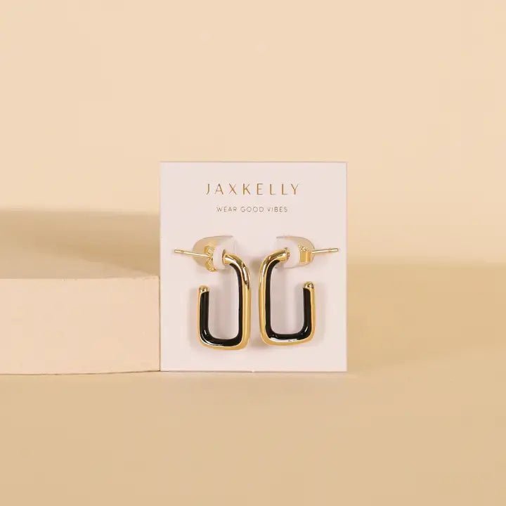 JaxKelly Black Enamel Large Rectangle Gold Hoop Earrings, designed to be hypoallergenic, are displayed on a white JaxKelly card against a beige background.
