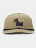 The Duck Camp Black Lab Hat features a tan polyester shell, adjustable fit, black trim above the brim, and an embroidered black Labrador holding a stick in its mouth.