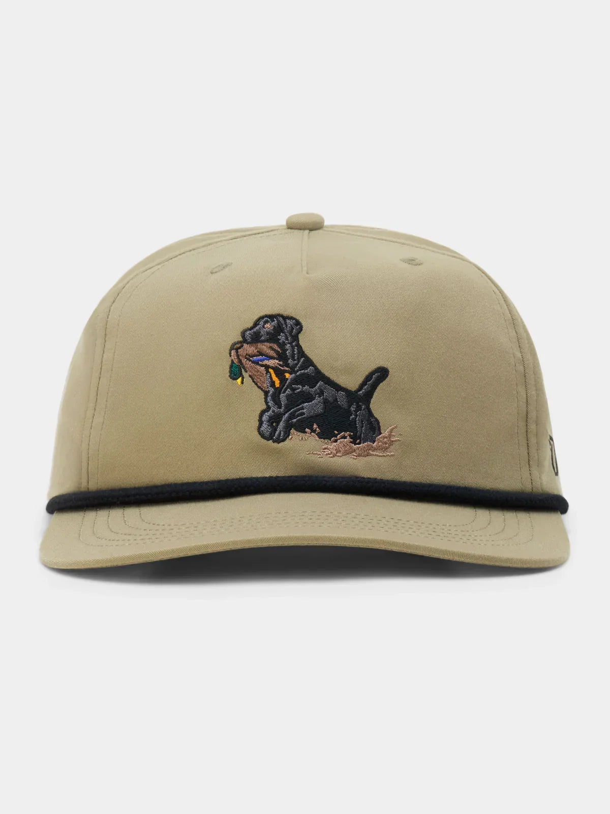 The Duck Camp Black Lab Hat features a tan polyester shell, adjustable fit, black trim above the brim, and an embroidered black Labrador holding a stick in its mouth.