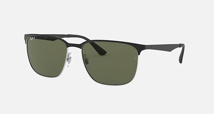 The Ray-Ban 3569 sunglasses feature a black metal frame with durable steel temples and rectangular green-tinted lenses, shown against a plain light background.