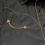 Close-up of the Broncbuster Snapshirt by Howler Brothers, featuring yellow piping, pearl snap buttons, and a pocket with decorative stitching and two triangular accents.