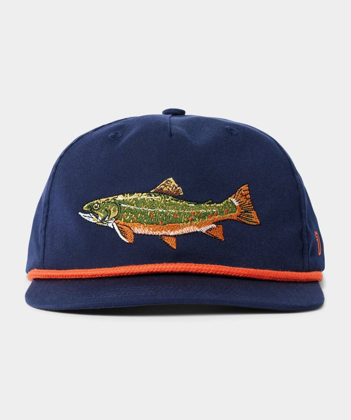 The Duck Camp Brook Trout Hat is a navy blue snapback with an embroidered fish on the front and orange trim along the brim.
