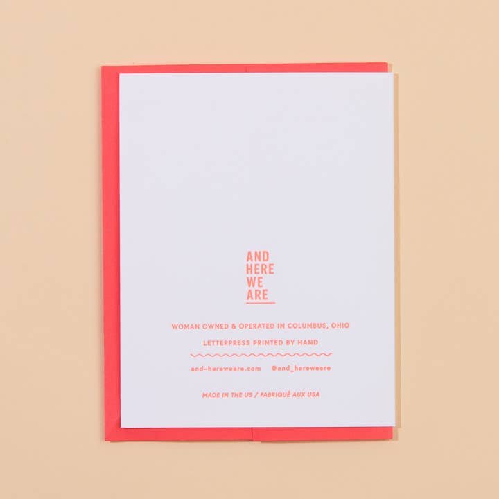 The Butter Together Card by And Here We Are is a white card with red text on a red envelope, featuring business info and the message: "And Here We Are. Woman owned & operated in Columbus, Ohio. Letterpress printed by hand.