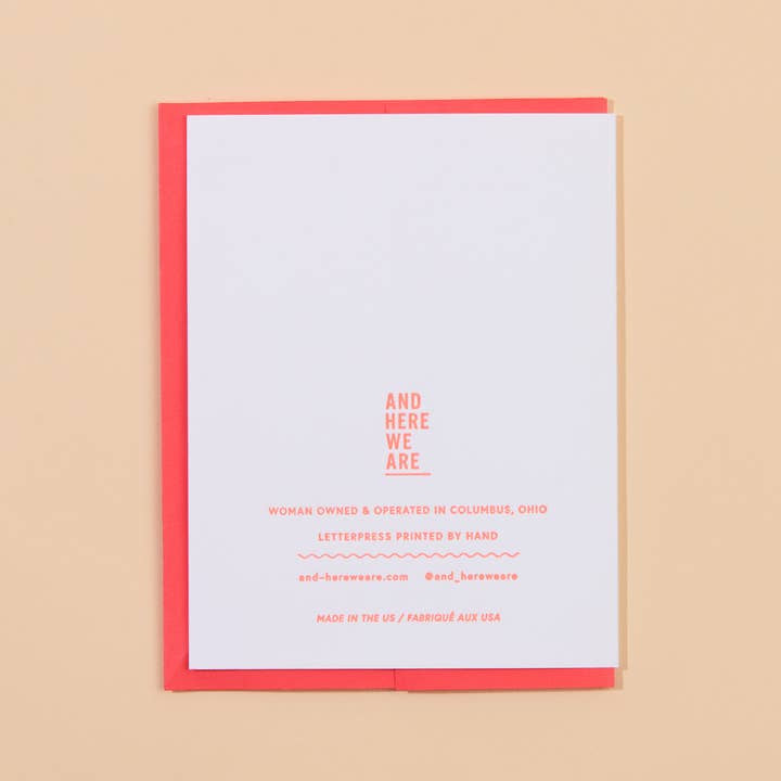 The Butter Together Card by And Here We Are features a red-bordered beige back with “AND HERE WE ARE” and business details letterpress printed in red ink.