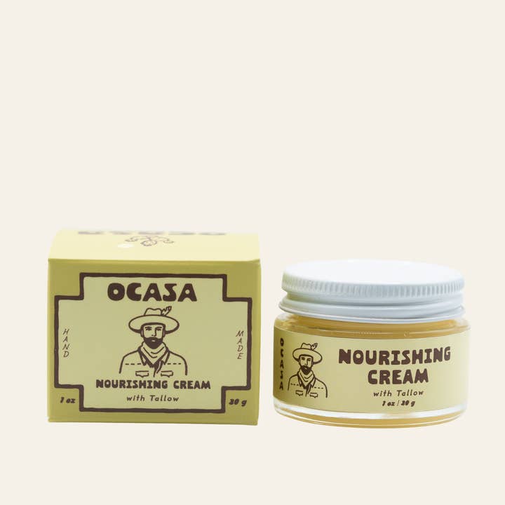 A jar of Nourishing Unscented Tallow Cream | OCASA next to its square box, both featuring a logo of a man in a wide-brimmed hat.