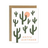 The Cactus Birthday Card by Worthwhile Paper features green cactus art, an orange sun, and "Happy Birthday" in orange text. Printed on recycled paper, it includes a brown envelope and is perfect for eco-friendly birthday wishes.