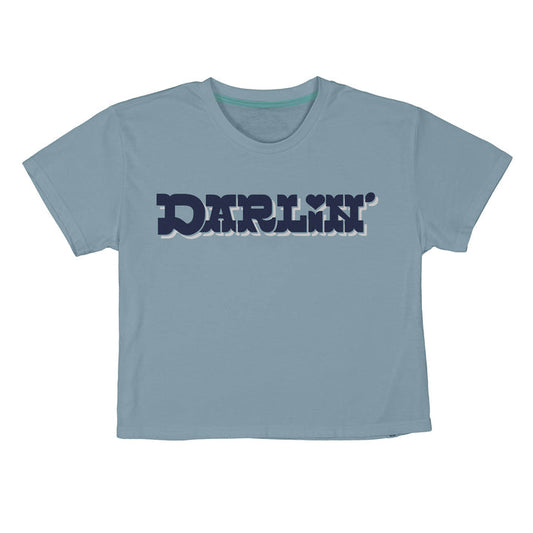 The Call Me Darlin' Boxy Tee by Sendero Provisions Co. features "DARLIN’" in bold, dark blue retro lettering with a heart over the “I”—a light blue shirt made for sparking friendly conversations and memorable introductions.