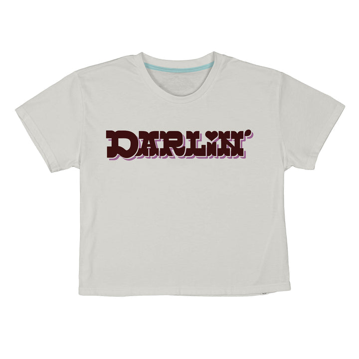 The Call me Darlin' Boxy Tee by Sendero Provisions Co. is a white, ultra-soft organic cotton cropped t-shirt with “DARLIN’” in bold retro maroon and pink on the chest—a modest crop perfect for everyday wear.