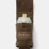 The Duck Camp Canvas Can Holster securely holds a canned beverage, featuring a brown waxed canvas pouch with an open flap that reveals the top of the can.