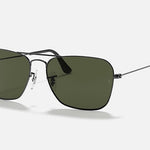 Inspired by Ray-Ban, the Caravan sunglasses feature a gunmetal square frame with green lenses, adjustable nose pads, and slim arms, shown on a simple light background.