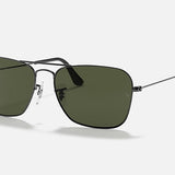 Ray-Ban Caravan sunglasses in gunmetal with green rectangular lenses offer a modern take on the classic Aviator style, shown against a white background.