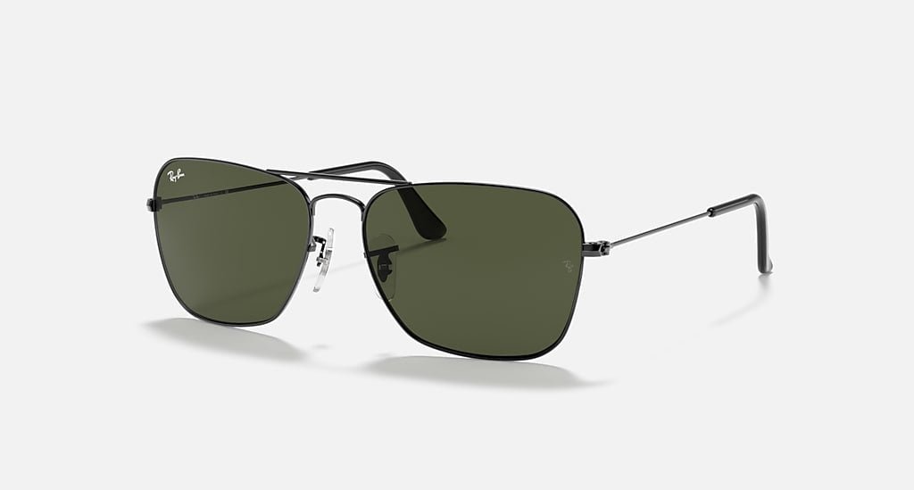 Ray-Ban Caravan sunglasses in gunmetal with green rectangular lenses offer a modern take on the classic Aviator style, shown against a white background.