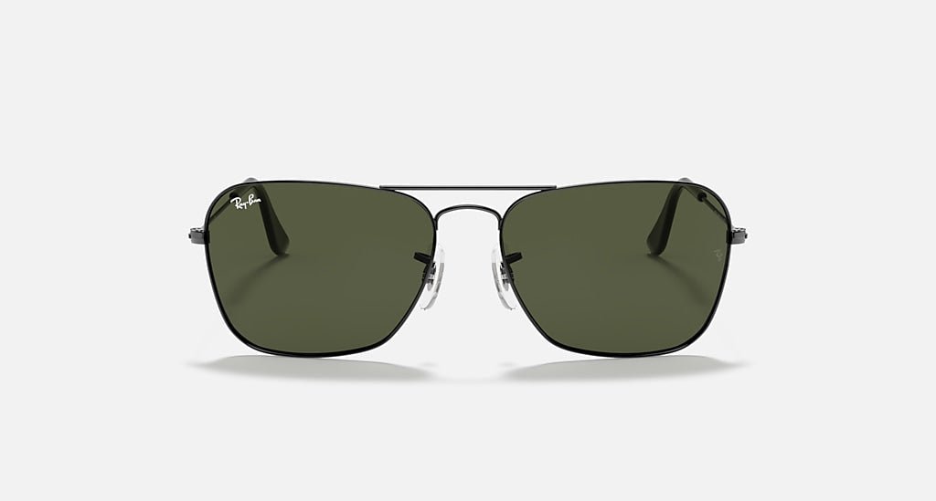 Front view of Ray-Ban Caravan sunglasses in gunmetal with green lenses, featuring a thin metal frame and the Ray-Ban logo on the top left lens—a classic, timeless style.
