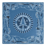 The Mollyjogger CCC Legacy Bandana is a blue 100% cotton accessory featuring "US Civilian Conservation Corps," a central pine tree, and border illustrations of trees, tools, forest scenes, and the CCC Worker Statue.