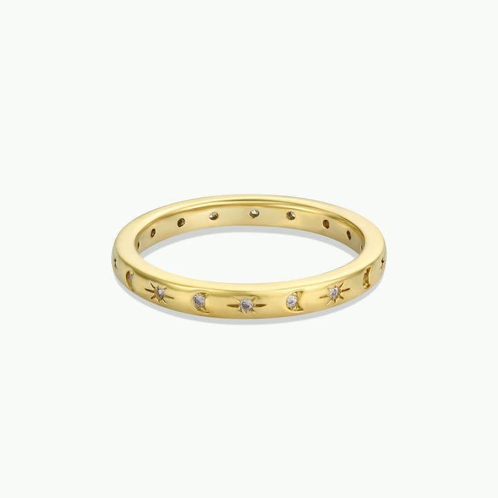 The Celestial Ring by JaxKelly features gold with star-shaped engravings and inset diamonds, displayed on a white background. This tarnish-free, hypoallergenic piece is perfect for daily wear.