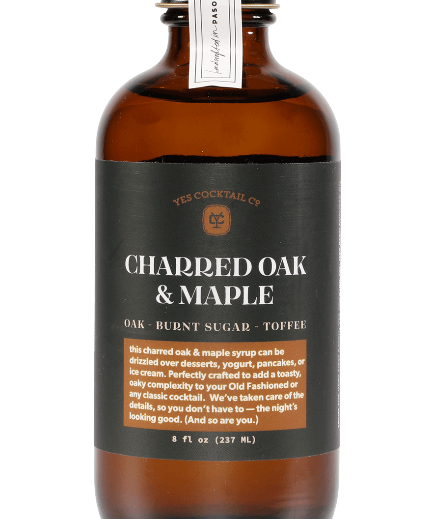 An 8 fl oz (237 ml) brown glass bottle of "Charred Oak & Maple" cocktail syrup by Yes Cocktail Co., featuring bourbon barrel aged oak, burnt sugar, and toffee flavors.