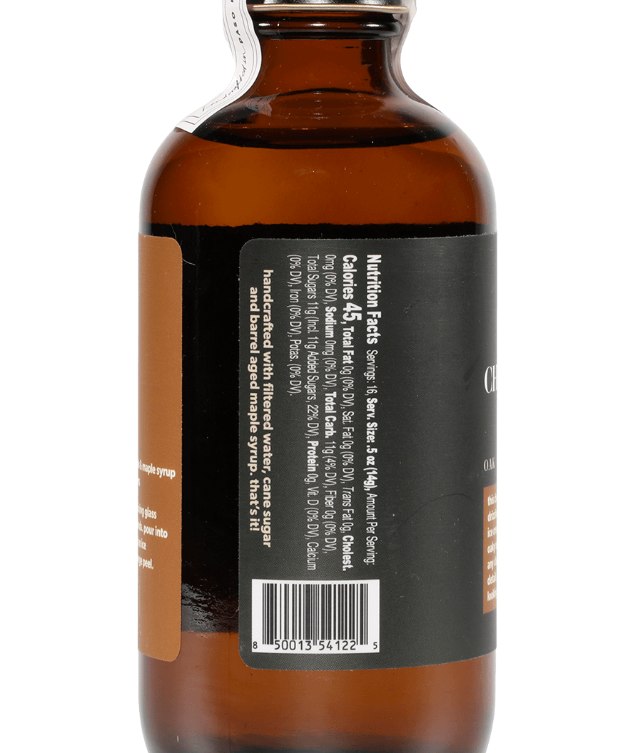 A brown glass bottle from Yes Cocktail Co. with a black label featuring nutritional facts, a barcode, and a tamper-evident seal—ideal for holding rich Charred Oak & Maple syrup.