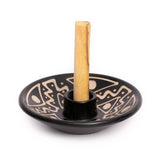 The Chulucanas Ceramics Palo Santo Holder by Luna Sundara is a black ceramic piece with tan geometric designs, crafted in Peru to hold a vertical wooden stick and highlight traditional handmade artistry.