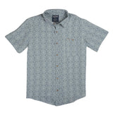 The City Slicker | Arizola Chevron from Sendero Provisions Co. is a light blue, short-sleeve, button-up shirt with a subtle geometric pattern, front chest pocket, and small label above the pocket.