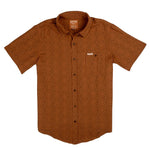 The City Slicker | Arizola Chevron by Sendero Provisions Co. is a short-sleeve, button-up shirt in burnt orange with a subtle chevron pattern, chest pocket, and collar—ideal for capturing cool desert vibes.