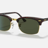 The Ray-Ban 3916 Clubmaster Square sunglasses feature dark green lenses, a tortoiseshell browline frame with gold accents, and slim temples—ideal for enhancing modern style—displayed against a plain light background.