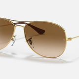 Ray-Ban 3362 Cockpit sunglasses feature thin metal frames, brown gradient lenses, adjustable nose pads, and black plastic arm tips—offering a timeless aviator style.