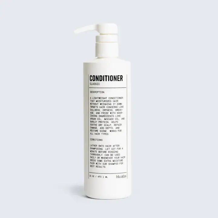 A white pump bottle labeled "Conditioner | Blu Atlas" features black text with description and instructions. This lightweight Blu Atlas conditioner, enriched with Argan Oil, moisturizes hair for a smooth, healthy finish.