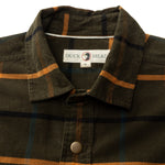 Close-up of the Duck Head Corduroy Plaid Snap Shirt featuring brown and green plaid cotton corduroy, orange and black stripes, a collar, metal snap buttons, and the Duck Head brand label.