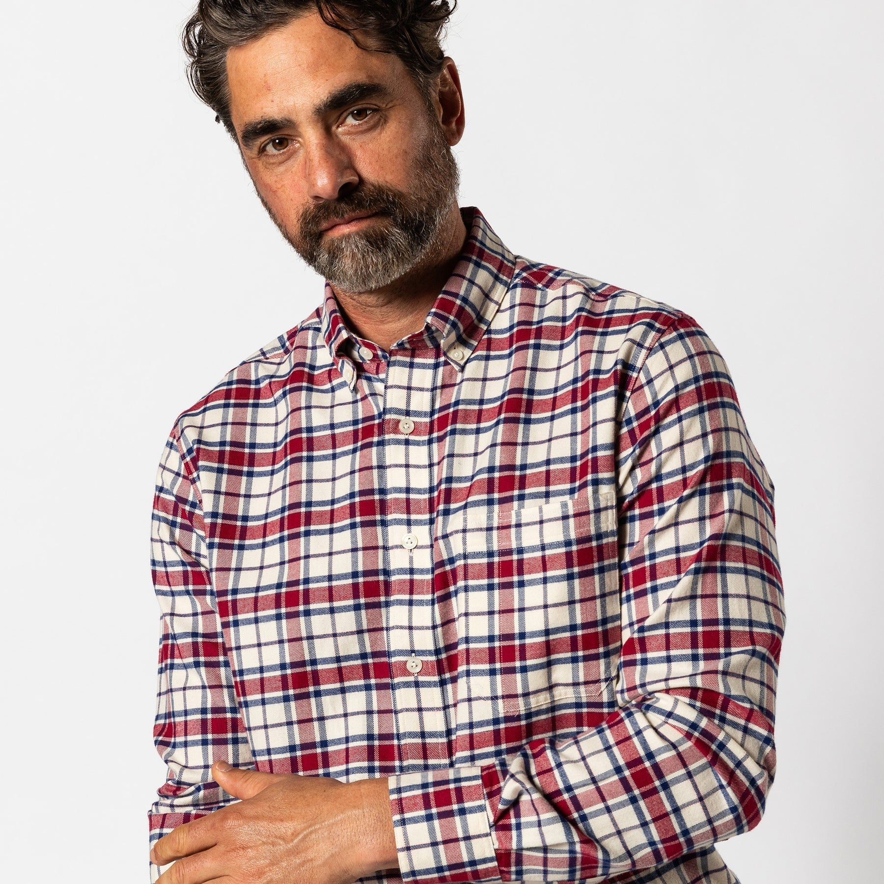 Man wearing the Duck Head Cotton Flannel Sport Shirt, featuring a red, white, and blue plaid pattern—ideal for fall adventures. Shown against a plain white background.