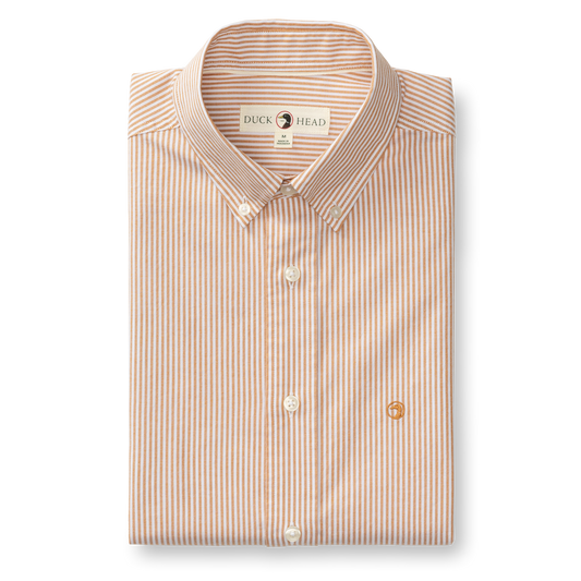 The Duck Head Cotton Oxford Sport Shirt Collins Stripe features orange and white vertical stripes, long sleeves, mechanical stretch, and an embroidered chest logo.