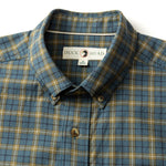 A close-up of a Duck Head Cotton Wool Sport Shirt, featuring a button-down collar and blue, brown, and gray plaid pattern with the "Duck Head" label inside the collar.