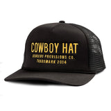 The Cowboy Hat by Sendero Provisions Co. is a black mesh trucker hat with yellow "COWBOY HAT" embroidery and "Sendero Provisions Co. Trademark 2014" on the front, perfect for keeping you cool.