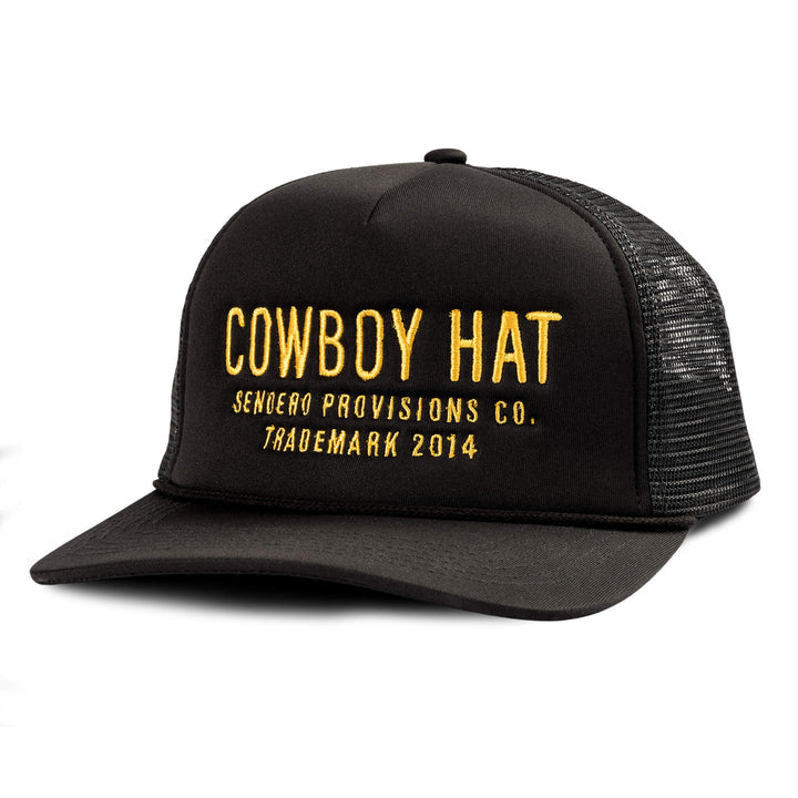 The Cowboy Hat by Sendero Provisions Co. is a black mesh trucker hat with yellow embroidered text, ideal for those wanting unique or standout headwear.