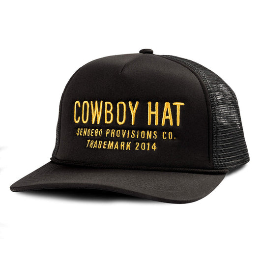 The Cowboy Hat by Sendero Provisions Co. is a black mesh trucker hat with yellow embroidered text, ideal for those wanting unique or standout headwear.