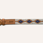 The Cowboy by Zilker Belts is a hand-stitched belt made from premium Argentine leather, with a brass buckle, blue and brown geometric pattern, and "ZILKER" stamped near the buckle.